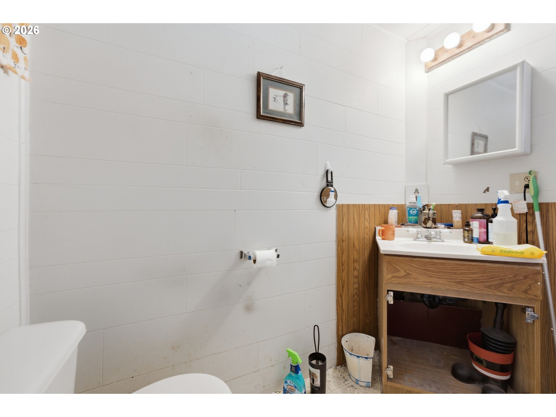 63605 South Barview Road Coos Bay, OR 97420 - Photo 25 of 28 a bathroom with a sink and a mirror