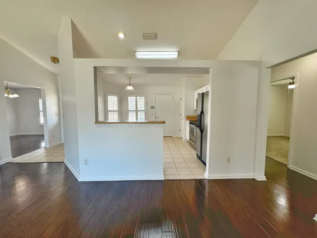 wooden floor in a room with a kitchen