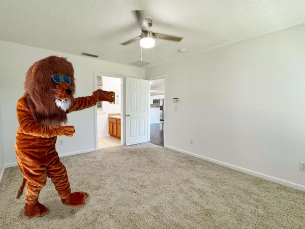 a living room with furniture and a ceiling fan