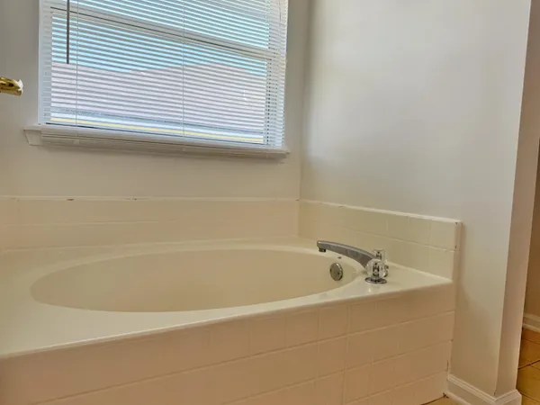 a white bath tub sitting next to a window