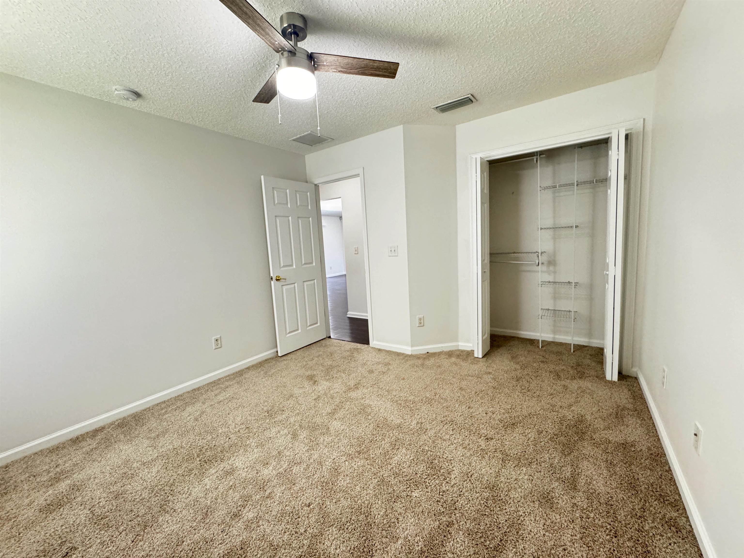 1709 South Summer Ridge Court St. Augustine, FL 32092 - Photo 21 of 27 an empty room with closet and a ceiling fan