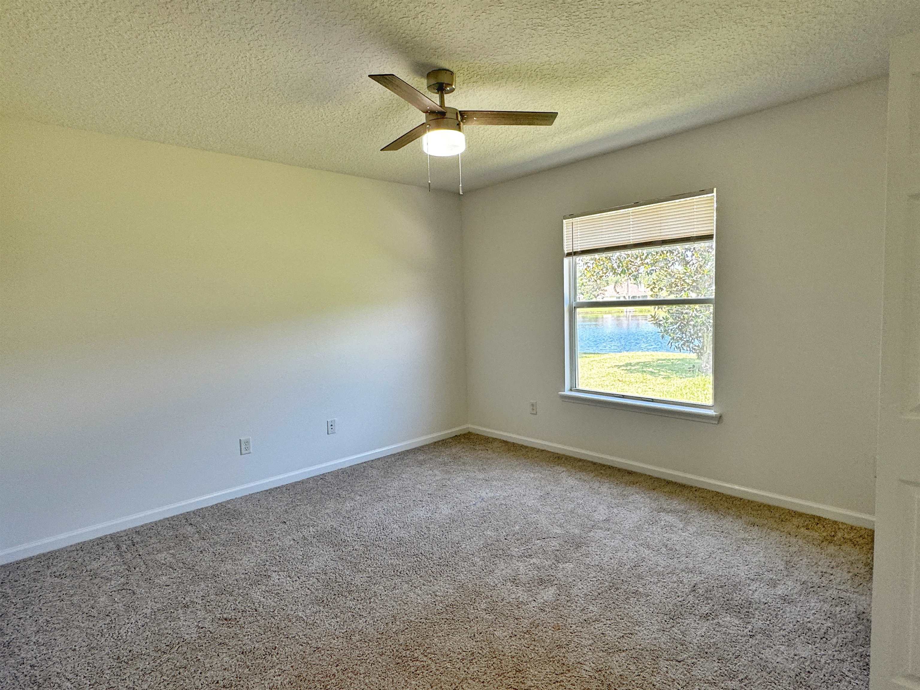 1709 South Summer Ridge Court St. Augustine, FL 32092 - Photo 22 of 27 an empty room with a window and a ceiling fan