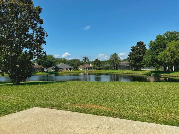 a view of a lake with a house in the background