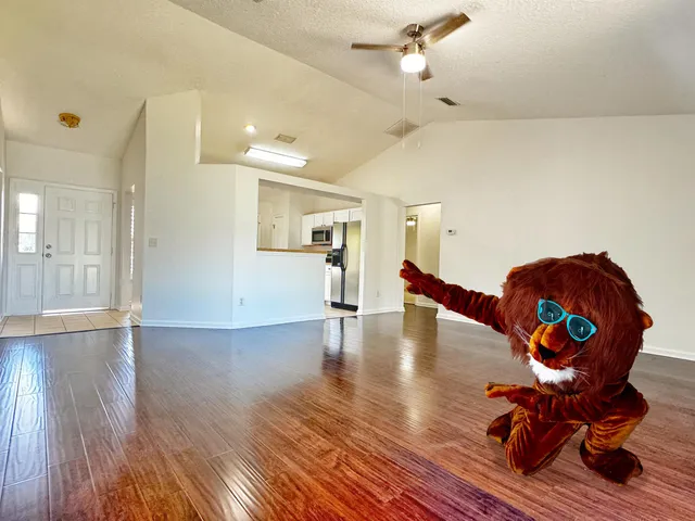 a view of livingroom and dining room with wooden floor