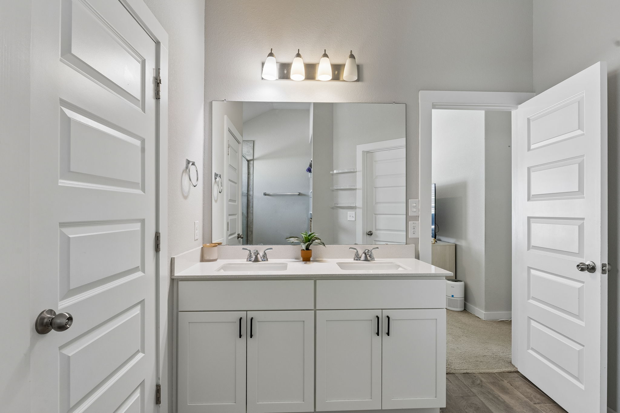 164 Appleberry Lane Elgin, TX 78621 - Photo 18 of 40 A classic double vanity offers ample under-sink storage beneath high ceilings.