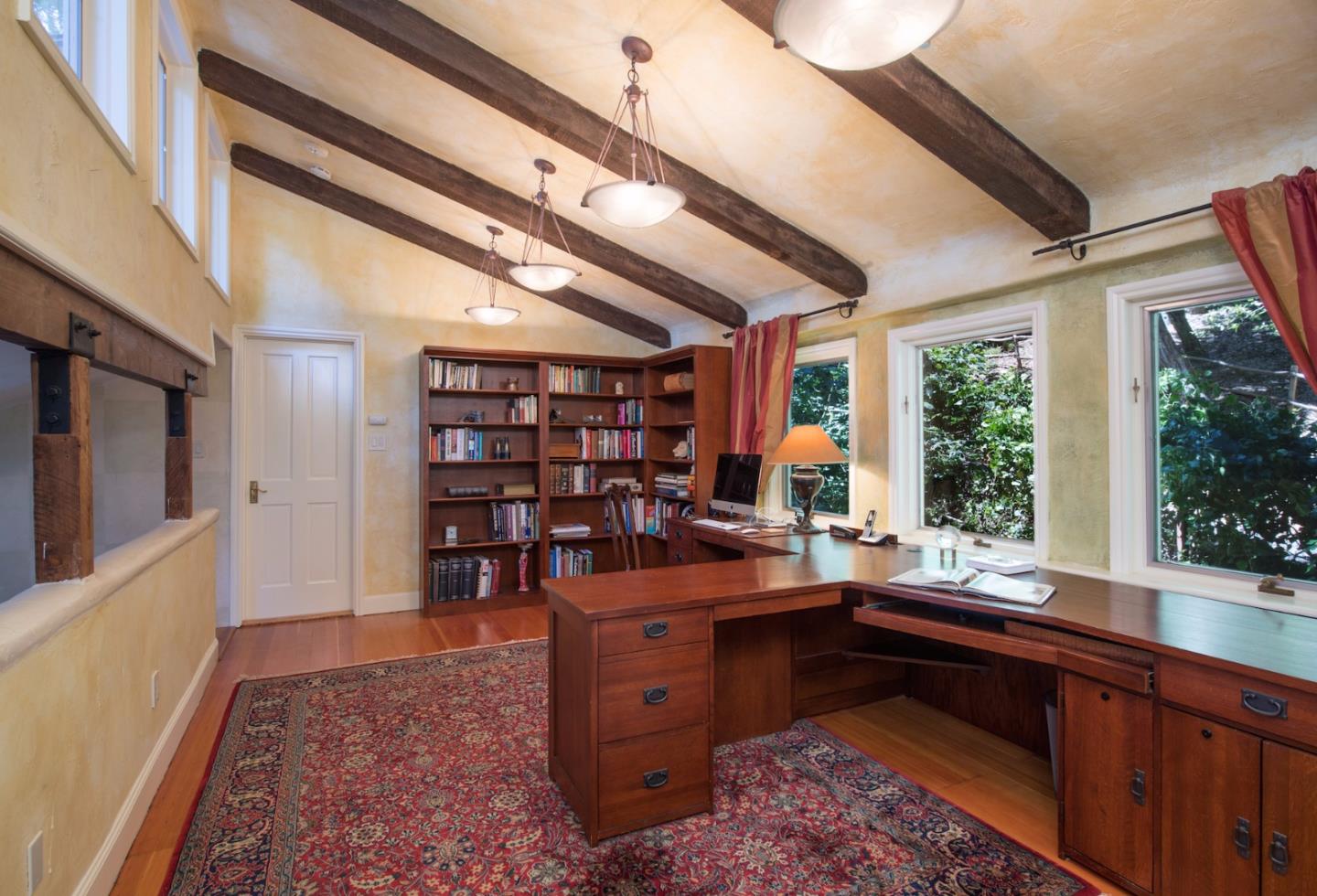 135 Summit Road Woodside, CA 94062 - Photo 11 of 27 a room with furniture a large window and bookshelf