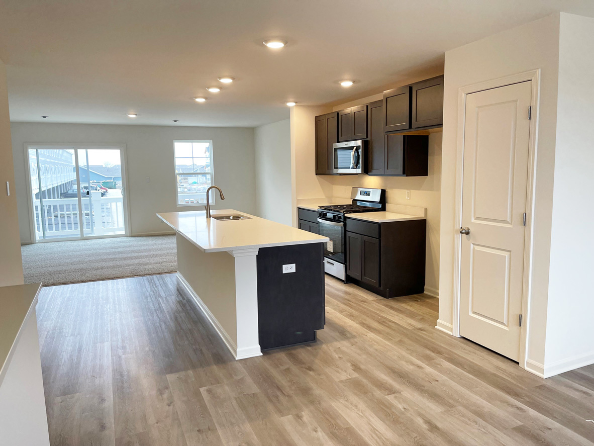 6388 Roscommon Road Tinley Park, IL 60477 - Photo 21 of 21 a large kitchen with stainless steel appliances kitchen island granite countertop a stove and a sink