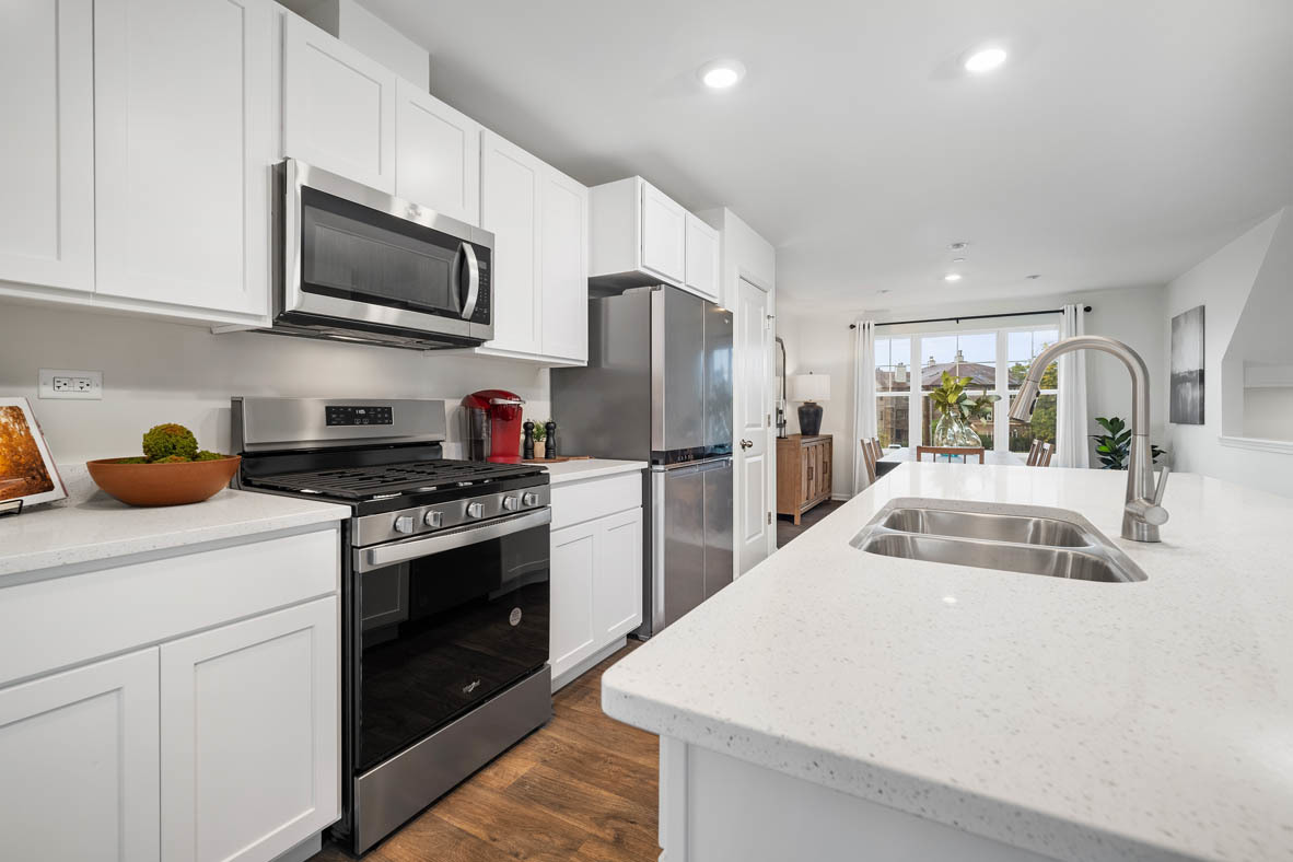 6388 Roscommon Road Tinley Park, IL 60477 - Photo 7 of 21 a kitchen with stainless steel appliances granite countertop a sink stove and refrigerator