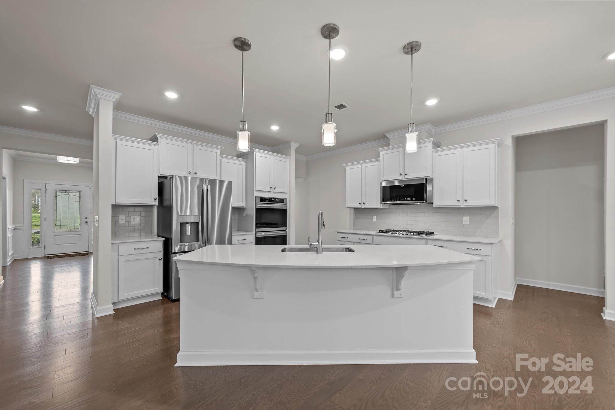15741 Queens Trail Drive Davidson, NC 28036 - Photo 12 of 48 a large kitchen with stainless steel appliances kitchen island a large counter top and stove