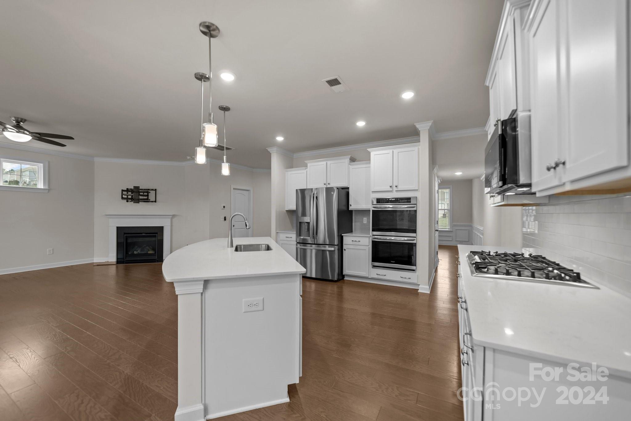 15741 Queens Trail Drive Davidson, NC 28036 - Photo 15 of 48 a kitchen with stainless steel appliances kitchen island granite countertop a stove and a refrigerator