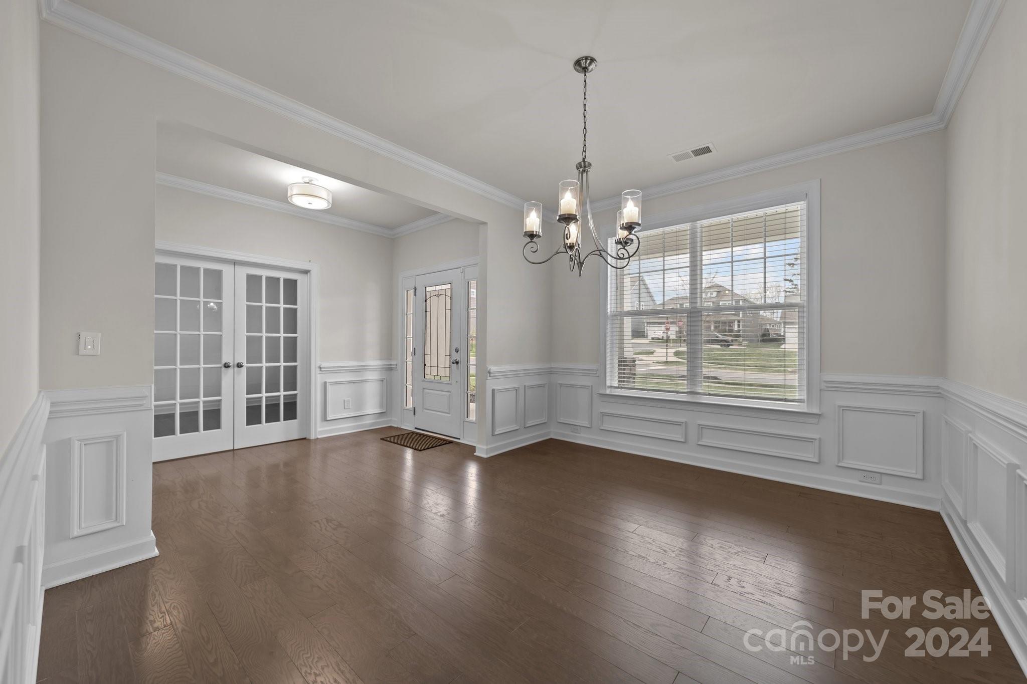 15741 Queens Trail Drive Davidson, NC 28036 - Photo 17 of 48 a view of an empty room with wooden floor and a window