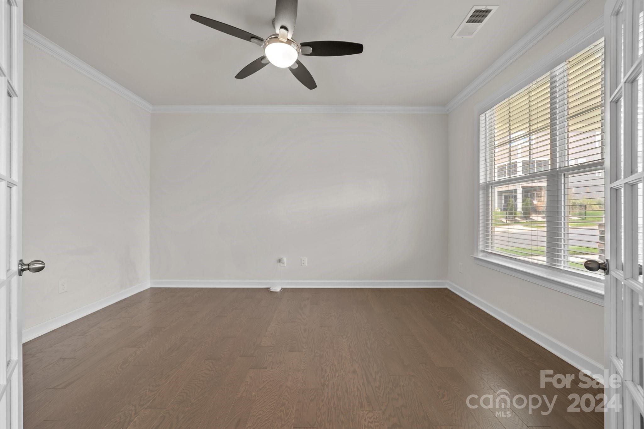 15741 Queens Trail Drive Davidson, NC 28036 - Photo 19 of 48 an empty room with a window and a fan