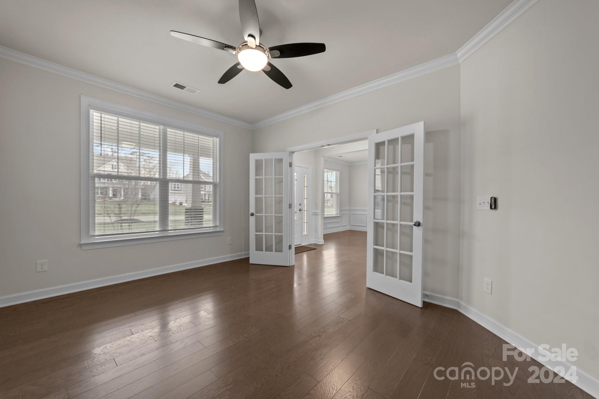15741 Queens Trail Drive Davidson, NC 28036 - Photo 20 of 48 a view of an empty room with wooden floor and a window