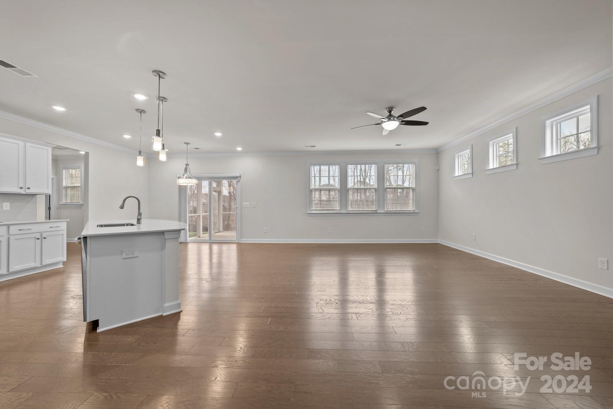 15741 Queens Trail Drive Davidson, NC 28036 - Photo 22 of 48 a view of an empty room with kitchen and window