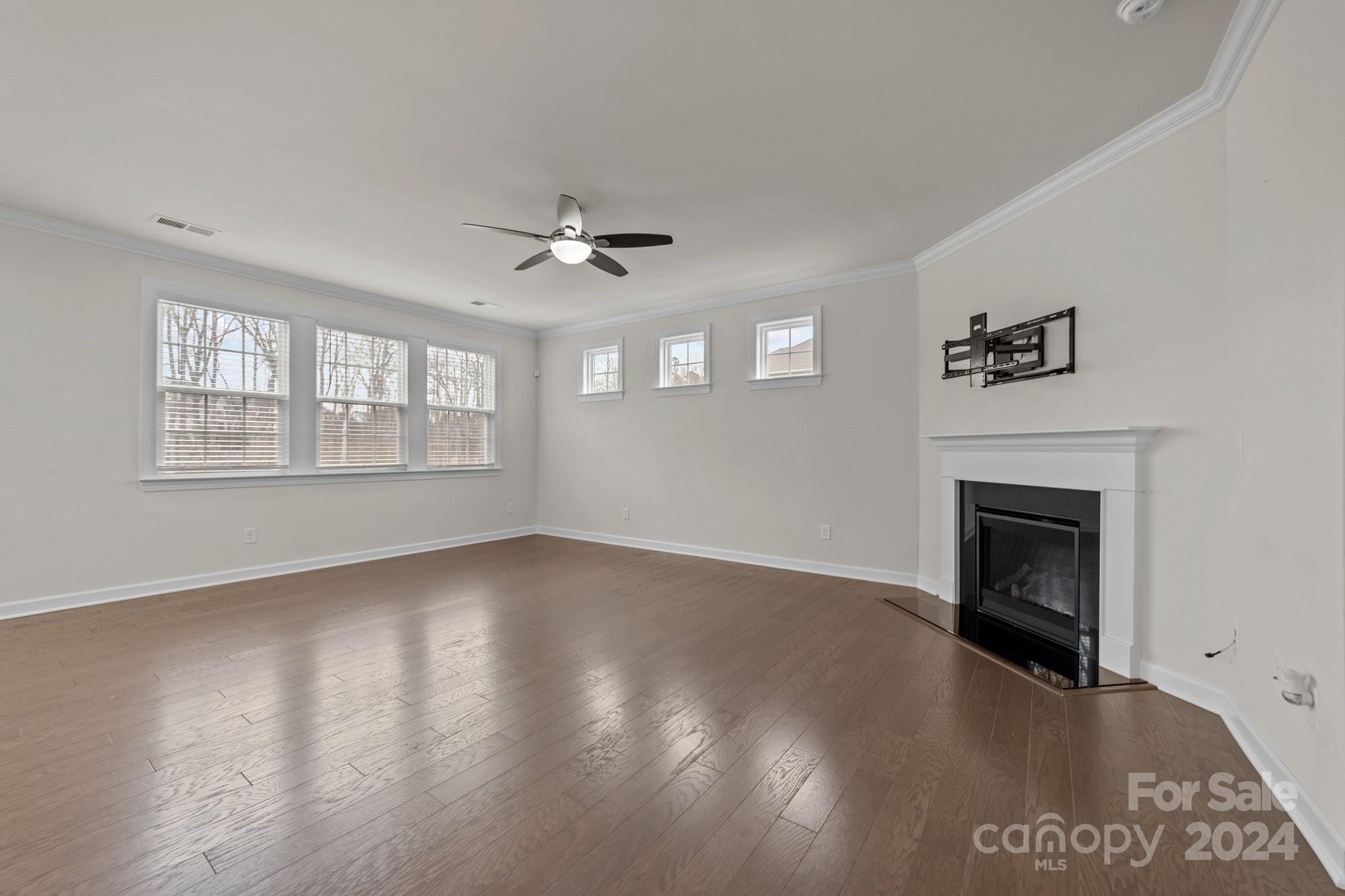 15741 Queens Trail Drive Davidson, NC 28036 - Photo 23 of 48 a view of an empty room with wooden floor and a window