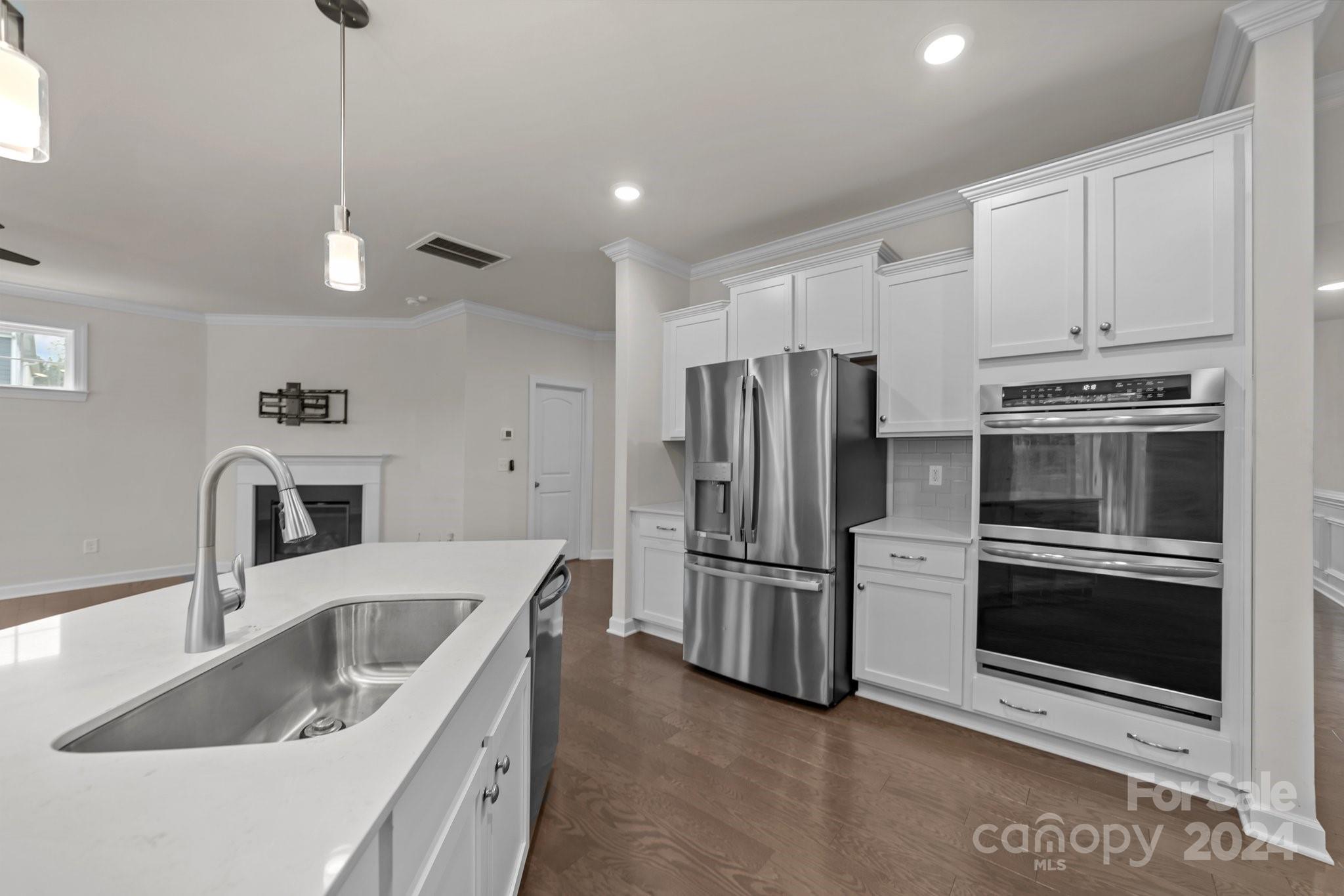 15741 Queens Trail Drive Davidson, NC 28036 - Photo 25 of 48 a kitchen with stainless steel appliances granite countertop a sink stove and refrigerator