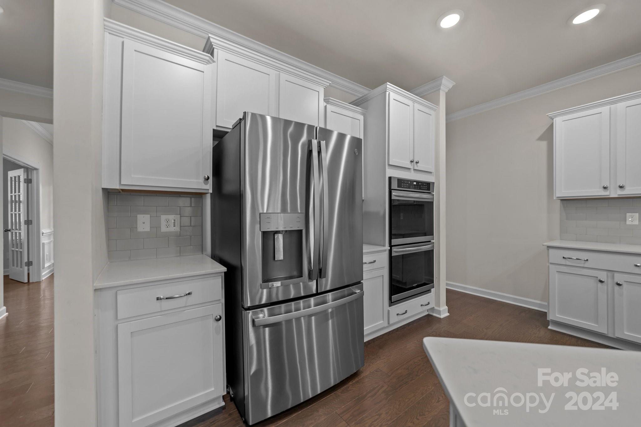 15741 Queens Trail Drive Davidson, NC 28036 - Photo 28 of 48 a kitchen with stainless steel appliances a refrigerator and cabinets