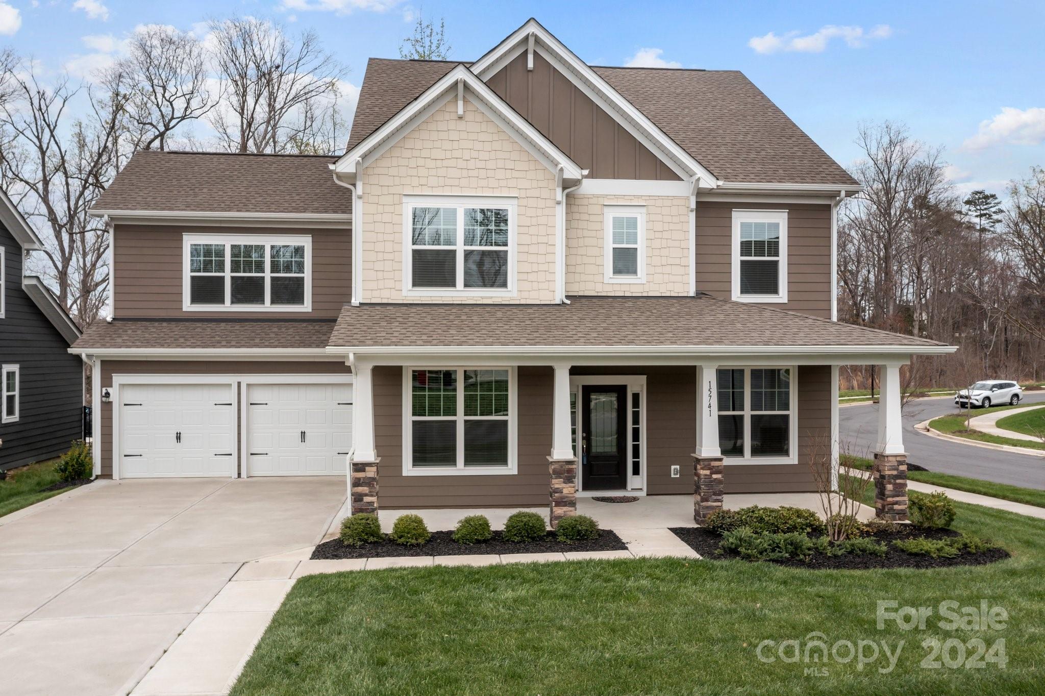 15741 Queens Trail Drive Davidson, NC 28036 - Photo 3 of 48 a front view of a house with a yard and garage