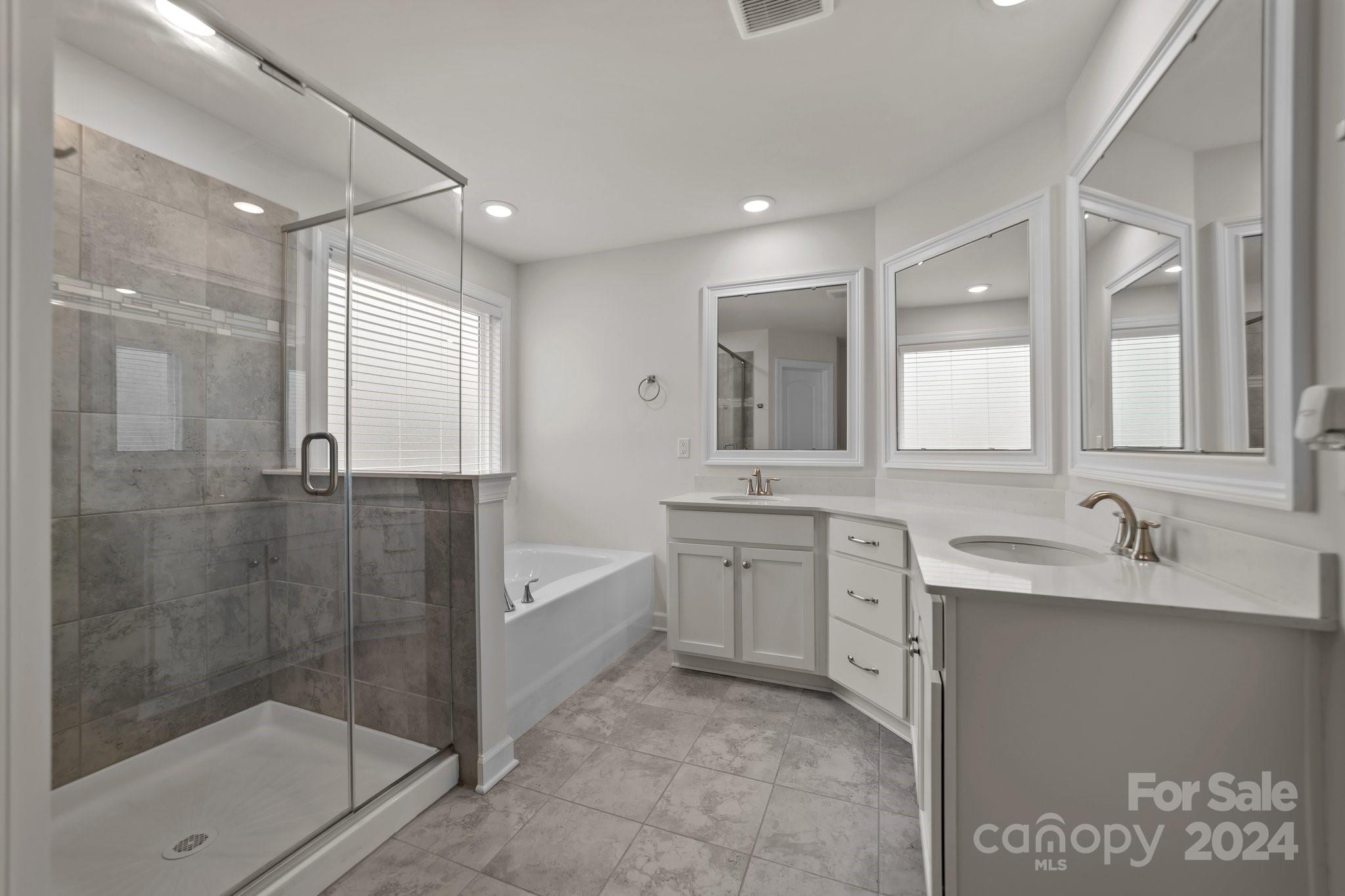 15741 Queens Trail Drive Davidson, NC 28036 - Photo 36 of 48 a bathroom with a granite countertop sink mirror and bathtub