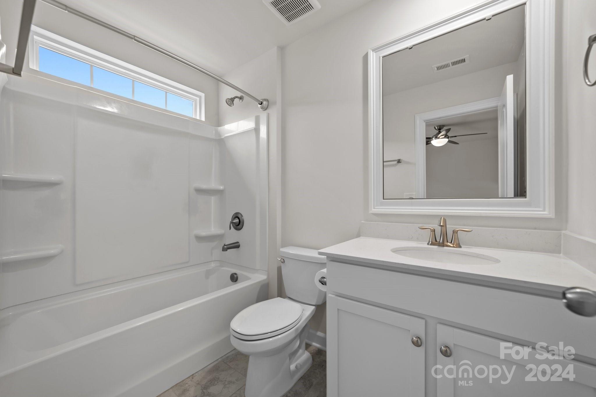 15741 Queens Trail Drive Davidson, NC 28036 - Photo 40 of 48 a bathroom with a sink a toilet and shower