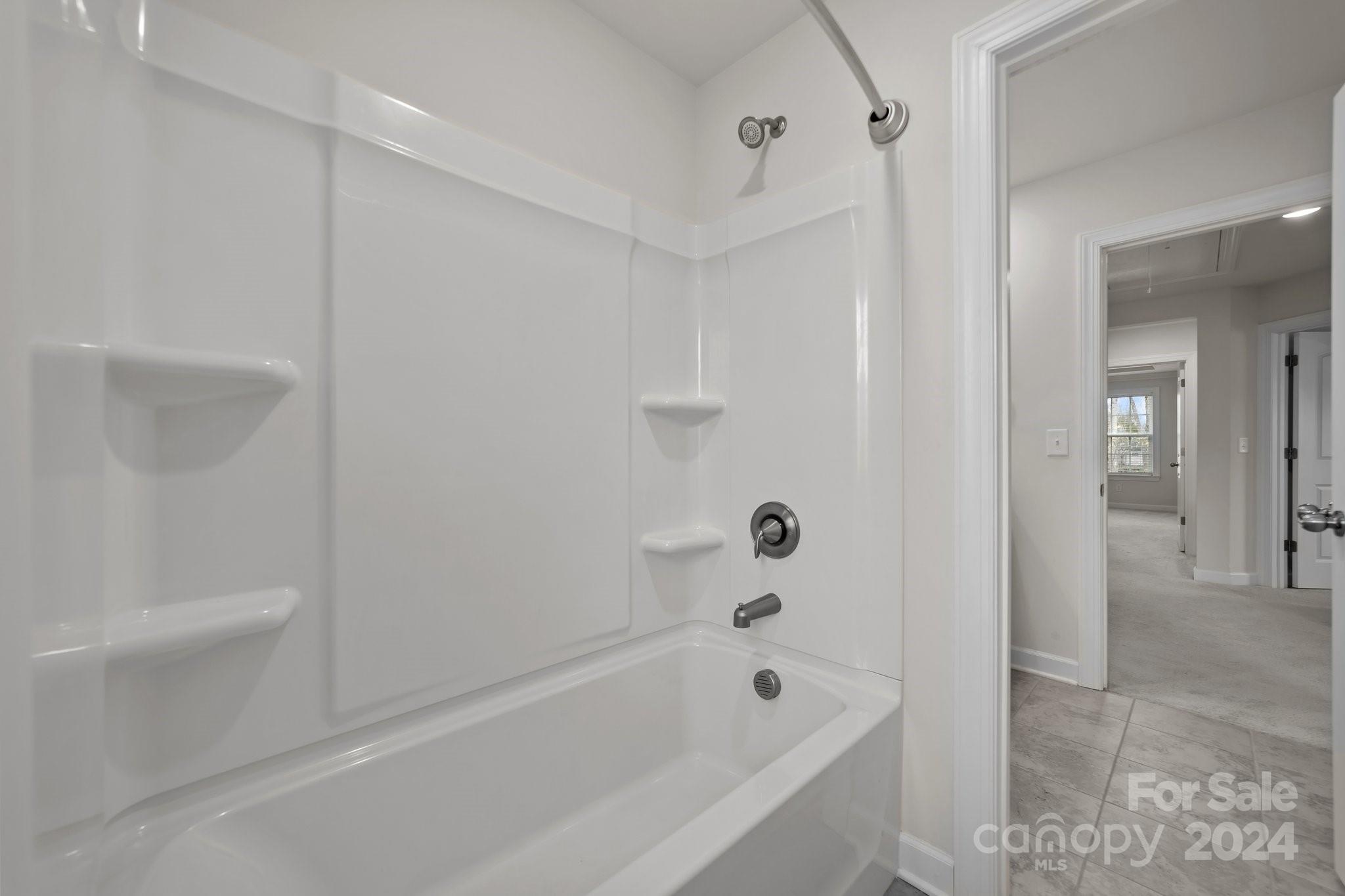 15741 Queens Trail Drive Davidson, NC 28036 - Photo 42 of 48 a bathroom with a bathtub and a shower