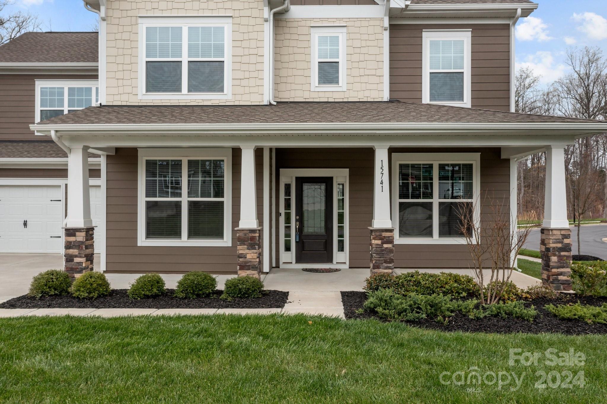 15741 Queens Trail Drive Davidson, NC 28036 - Photo 5 of 48 front view of a brick house with a yard