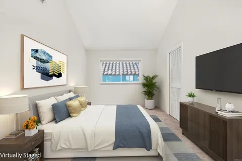 a bedroom with a bed and a flat screen tv