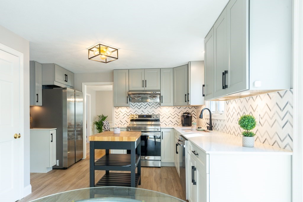 6 King Street Arlington, MA 02474 - Photo 1 of 37 a kitchen with stainless steel appliances a sink a stove a refrigerator cabinets and a dining table