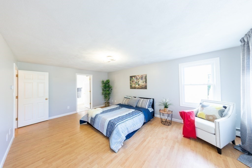 6 King Street Arlington, MA 02474 - Photo 18 of 37 a spacious bedroom with a bed and a couch