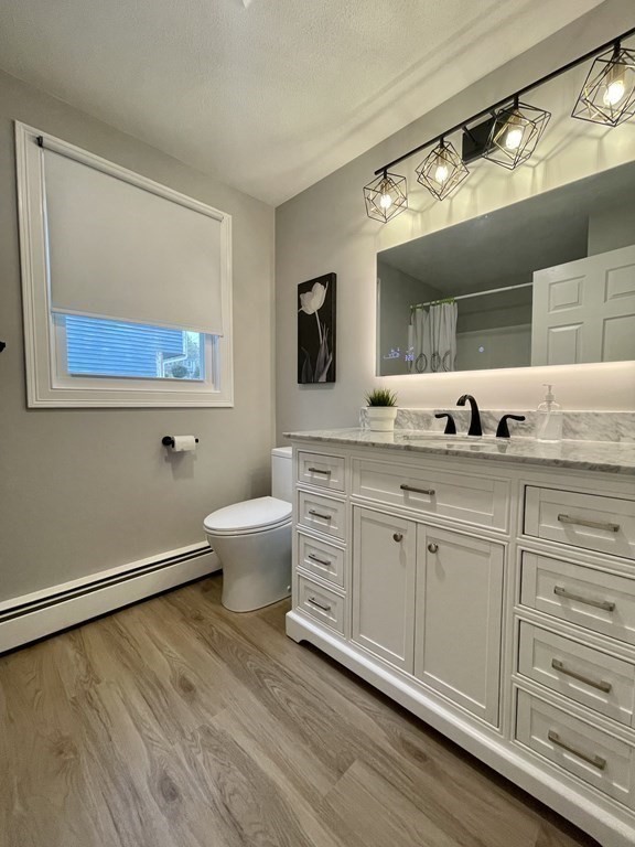 6 King Street Arlington, MA 02474 - Photo 25 of 37 a spacious bathroom with a granite countertop sink mirror and toilet