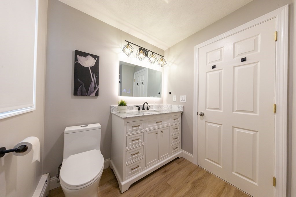 6 King Street Arlington, MA 02474 - Photo 29 of 37 a bathroom with a toilet a sink and mirror