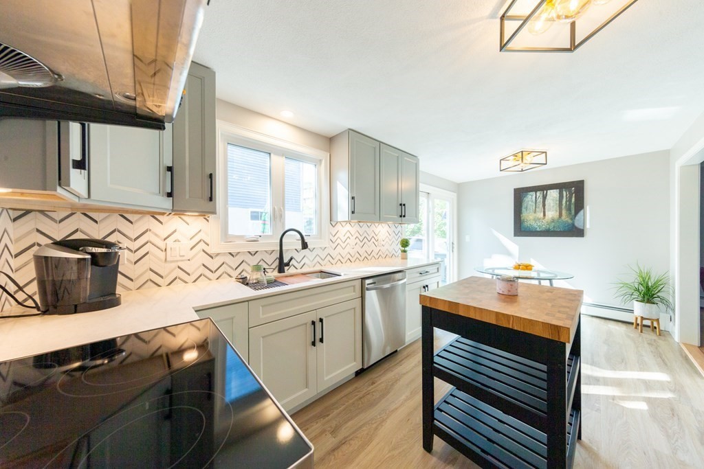 6 King Street Arlington, MA 02474 - Photo 3 of 37 a kitchen with a sink stove and cabinets