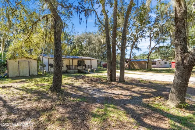 a view of a house with a tree in the background