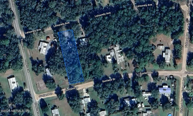 an aerial view of a residential apartment building with outdoor space and trees all around