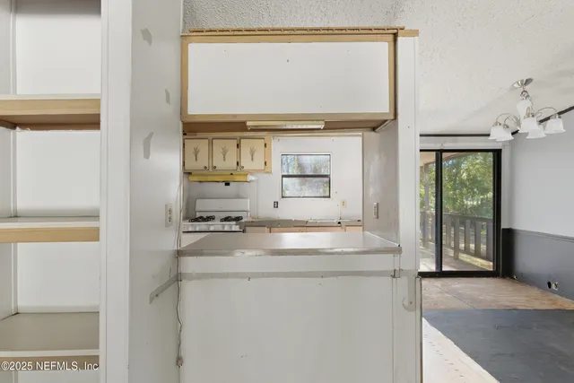 a kitchen with a sink stove and refrigerator
