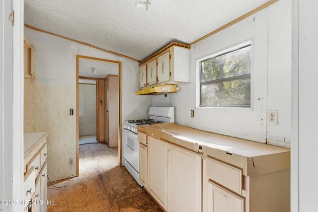 a kitchen with a stove and a refrigerator