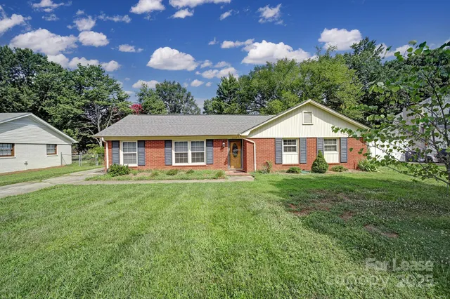 a front of a house with a garden and porch