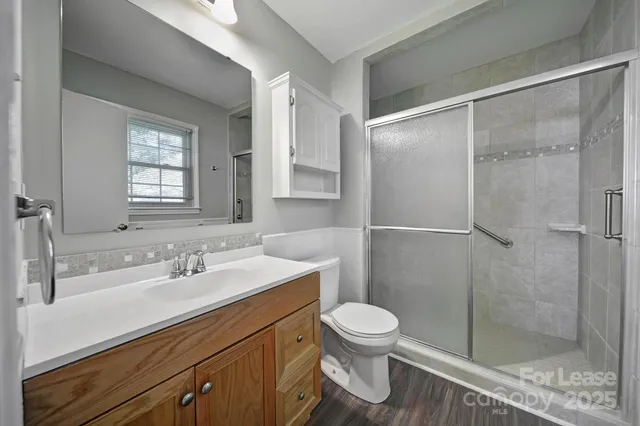 a bathroom with a sink mirror and a shower