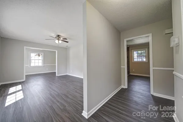 a view of livingroom with hardwood floor and kitchen view
