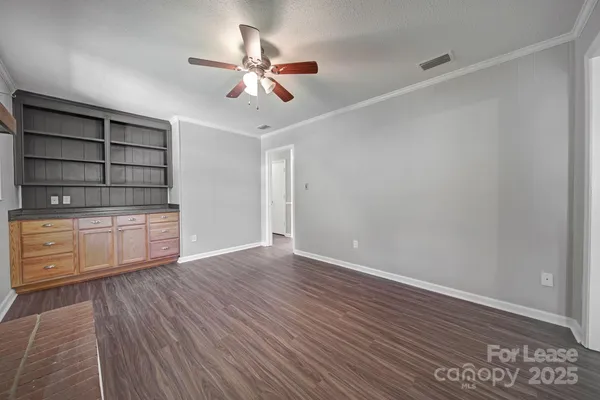 a view of a room with wooden floor and cabinet