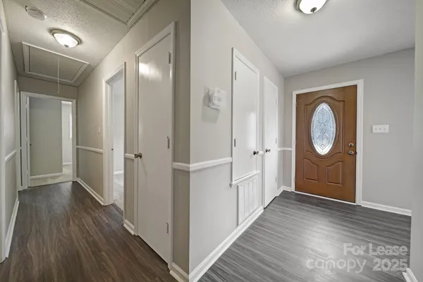 a view of a hallway with wooden floor