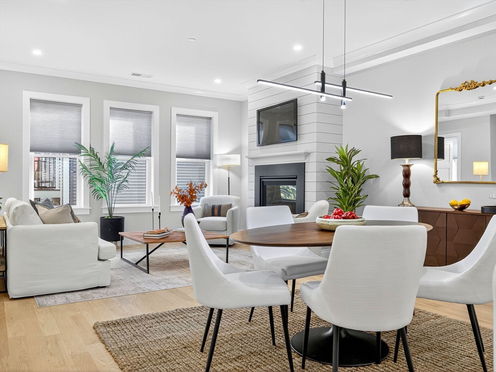 a living room with furniture a table and a fireplace
