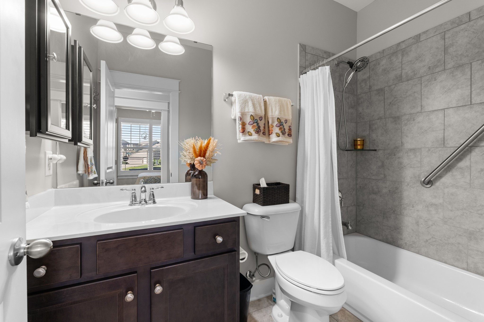 259 Caroline Way Mount Juliet, TN 37122 - Photo 19 of 35 a bathroom with a sink a toilet a mirror a vanity and shower