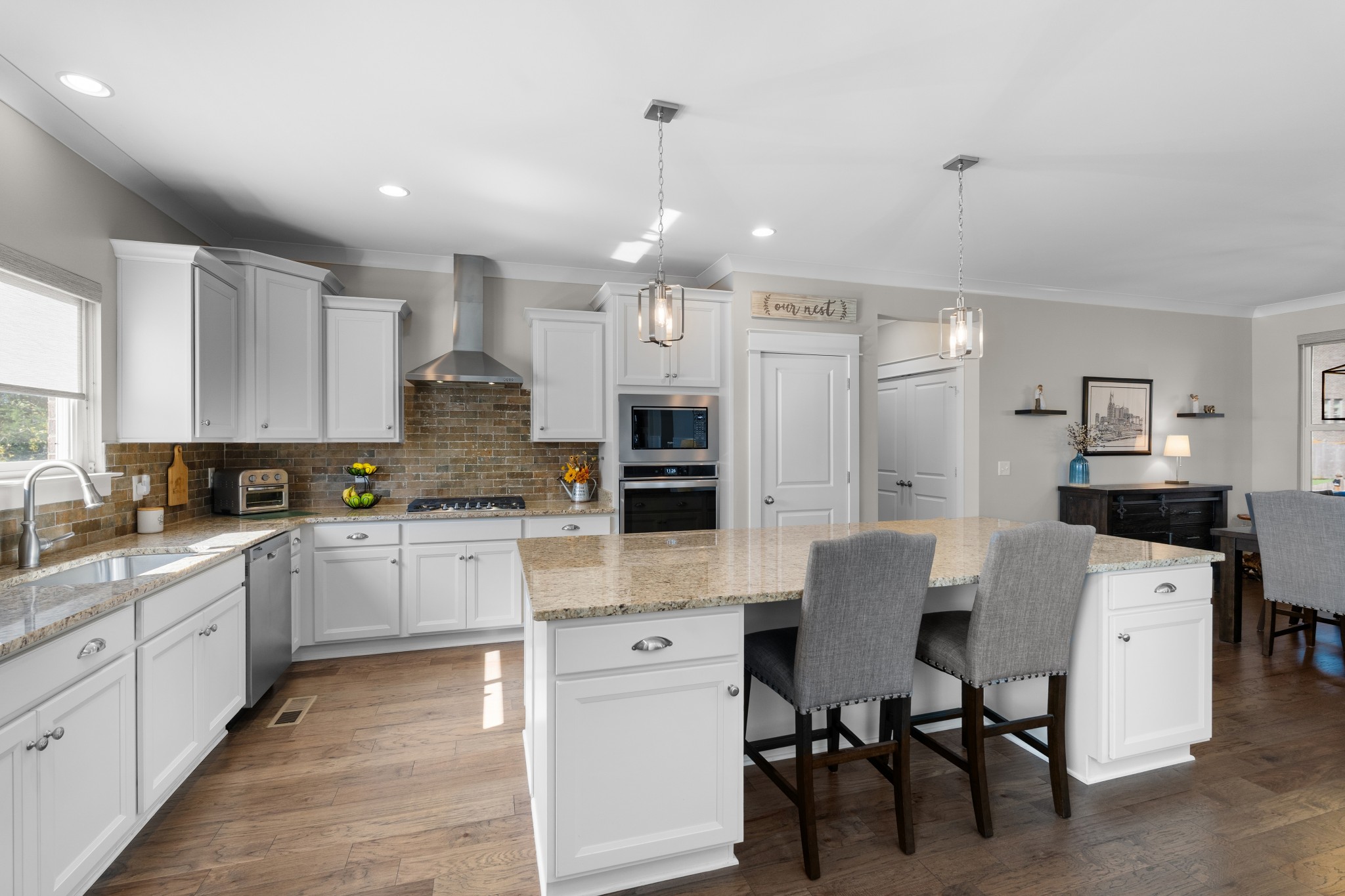 259 Caroline Way Mount Juliet, TN 37122 - Photo 5 of 35 a large kitchen with cabinets chairs and white appliances