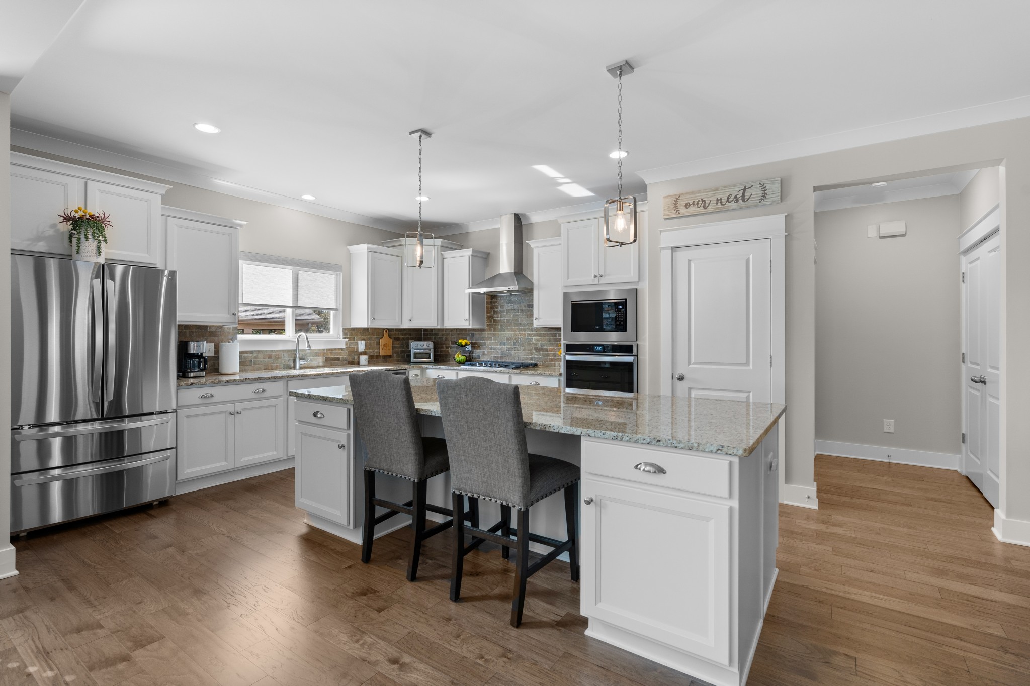 259 Caroline Way Mount Juliet, TN 37122 - Photo 6 of 35 a kitchen with kitchen island white cabinets and stainless steel appliances