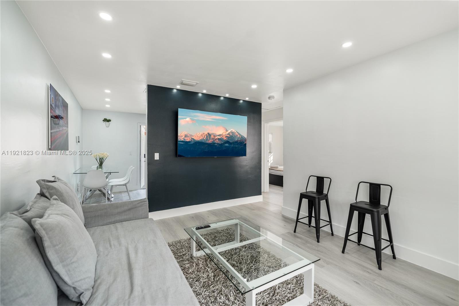 4421 Northwest 9th Street, Unit 4421 Miami, FL 33126 - Photo 1 of 14 a living room with furniture and a flat screen tv