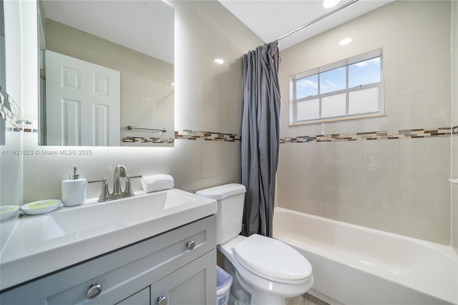 4421 Northwest 9th Street, Unit 4421 Miami, FL 33126 - Photo 11 of 14 a bathroom with a sink a toilet and shower