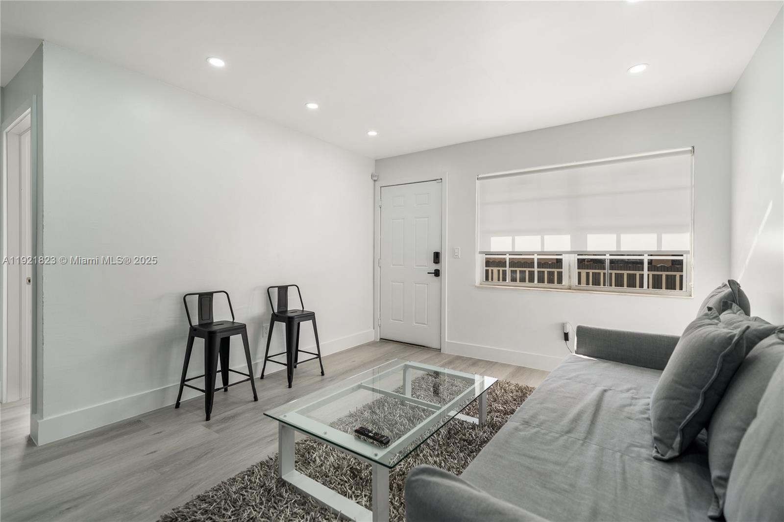 4421 Northwest 9th Street, Unit 4421 Miami, FL 33126 - Photo 2 of 14 a living room with furniture and a table