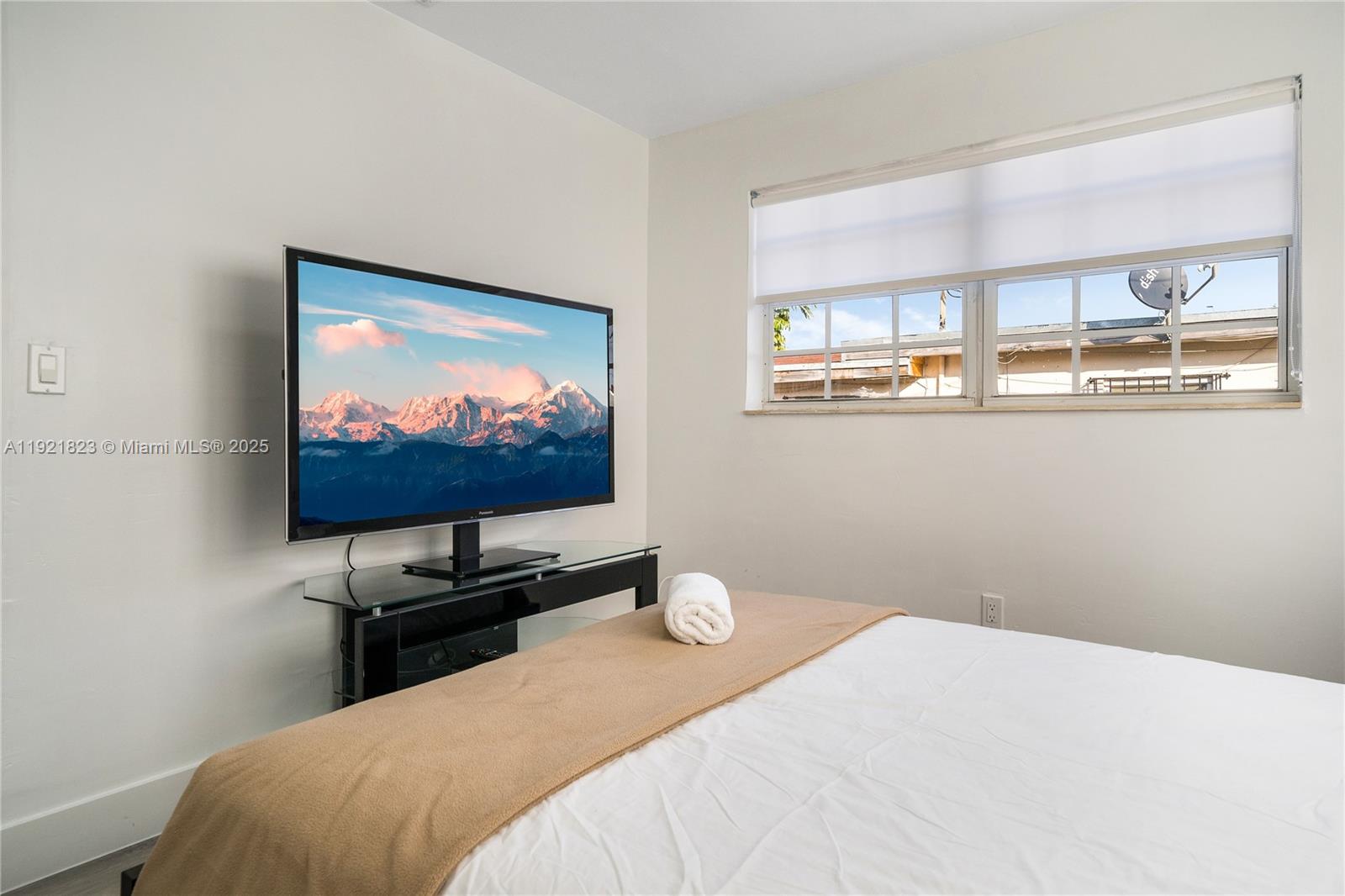 4421 Northwest 9th Street, Unit 4421 Miami, FL 33126 - Photo 9 of 14 a bedroom with a bed and a flat screen tv