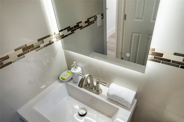 a bathroom with a sink mirror and vanity